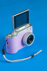 Cheap Pink Digital Camera on Blue Background