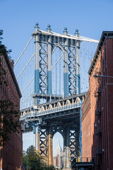 The Manhattan Bridge with the Empire State Building in New York City seen from the famous viewpoint in Dumbo, Brooklyn