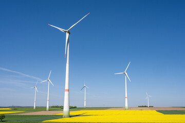 Wind turbines in fields of blooming canola seen in Germany