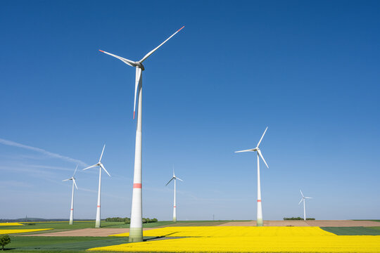 Wind turbines in fields of blooming canola seen in Germany