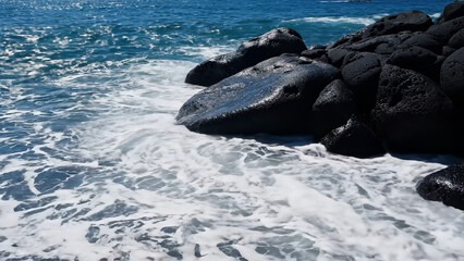 Mighty ocean waves crash into jagged black rocks on wild coastline, sending foamy spray. Power of sea against dark rocks, dramatic and rugged seascape filled with natural energy and coastal beauty