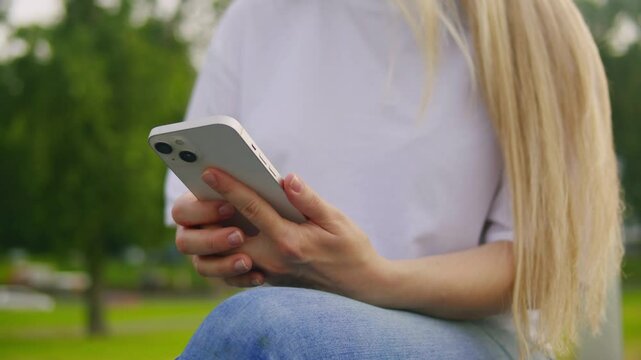 Woman chatting online on smartphone macro close up, typing text message, touching touchscreen keyboard, using messenger application. Female holding mobile phone, close up, swiping social media. 