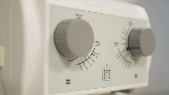Plastic knobs on dosimeter control panel twist under user fingers for fine radiation adjustment. Smooth turns enhance precise operation