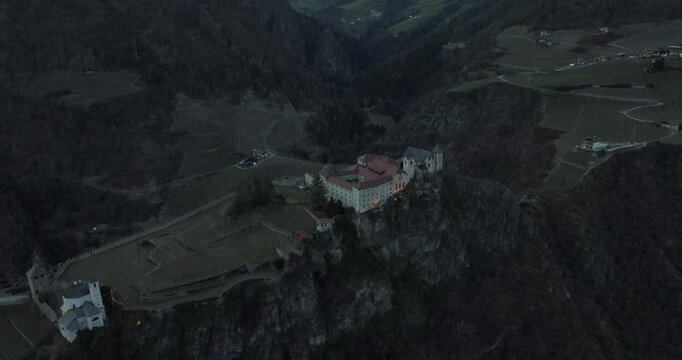 Aerial view of Chiusa, Sabiona Monastery and dolomites at twilight, Italy.