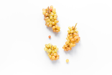 Many bunches of ripe yellow grapes on white background, top view