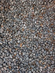 Decorative crushed stone texture with tiny multicolor pebbles, ideal for paving, gardening, and...