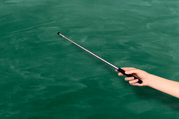 A teacher, lecturer, professor points at the blackboard. back to school