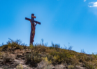 Rustic wooden cross overlooking the vast, dramatic landscape of Salta, Argentina. Represents a...