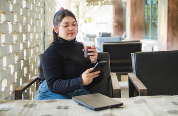 Young business woman manager asian one person sit on sofa smile cheerful hand holding tablet and...
