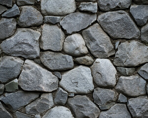 Fototapeta premium Old grey stone wall with natural rock texture and rough surface