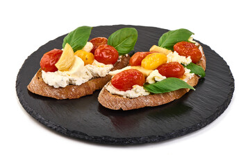 Bruschetta with cream cheese, cherry tomatoes and basil, isolated on white background
