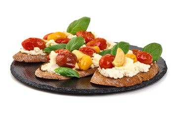 Bruschetta with cream cheese, cherry tomatoes and basil, isolated on white background
