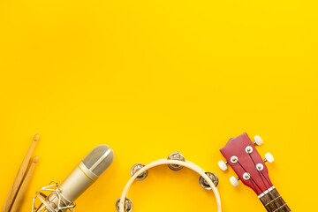 Musical instruments for band - small guitar, drumsticks and tambourine with studio microphone....