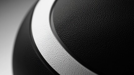 Close-up black medicine ball, textured surface, white stripe, gray background, fitness