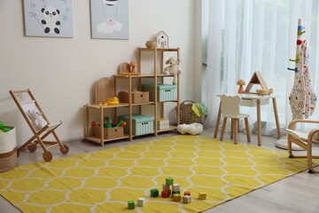 Stylish playroom with toys and furniture. Interior design