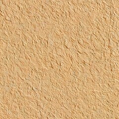 Close up of a textured beige wall with a cracked and peeling paint surface