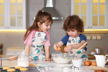 Cooking recipe. Cute children making dough for cookies at table in kitchen