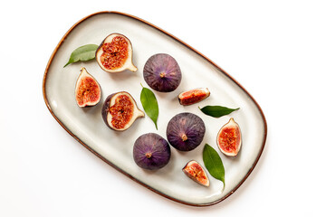Fresh ripe figs on a plate top view on a white background