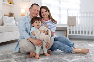 Fototapeta premium Cute little boy and his parents at home. Lovely family