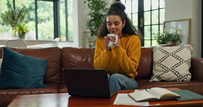 Woman, laptop and coffee on sofa for budget, credit score and happy for investment growth in living room. Person, smile and computer with tea, drink and results with tax compliance on couch in home