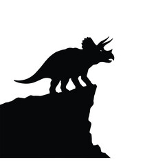 Black silhouette of a triceratops dinosaur on a rocky cliff © dipu