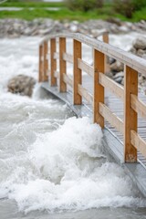 Raging water flooding a small wooden bridge