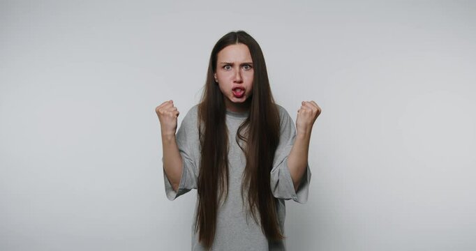 Emotional expression captured during indoor artistic performance in a minimalist setting with dramatic gestures