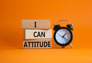 I Can Attitude symbol. Wooden blocks with words I Can Attitude. Beautiful orange background with...