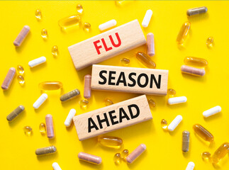 Flu Season Ahead symbol. Concept word Flu Season Ahead on wooden blocks. Beautiful yellow...