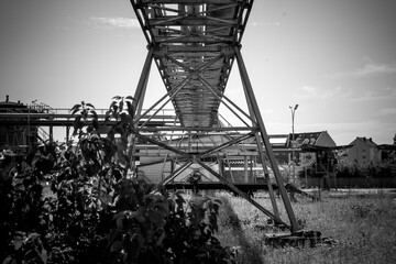 Industrial landscape showcases the stark beauty of abandoned structures under a clear sky at midday