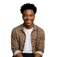 A cheerful young man with great natural hair smiles widely in a patterned shirt and white tee