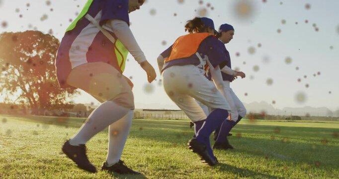 Seven softball players jogging on field, lowering into crouch then sprinting for power training