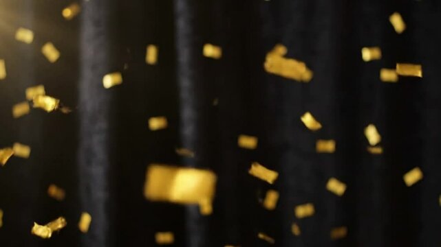 Golden Confetti Falling on Black Background Festive Celebration Image