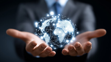 Businessman holding a glowing digital globe with connected nodes, symbolizing global communication and network technology.
