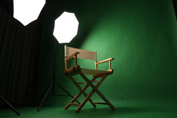 Chair of Film Director. Directors chair in green screen studio setup with softbox lighting. Ideal...