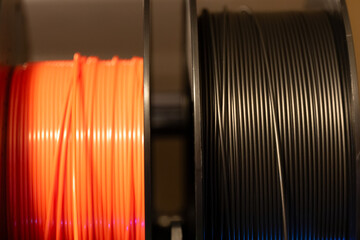 Selective focus on different colored spools of 3d printer filament 