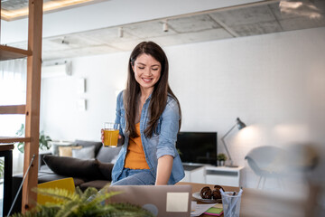 Freelancer working from home and drinking orange juice