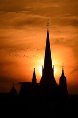 Obraz premium Silhouette of church at sunset, religious architecture, cathedral tower, gothic style