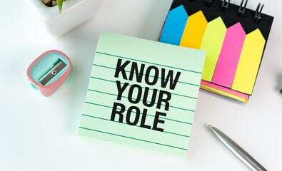 A green notepad with the words Know Your Role written on it