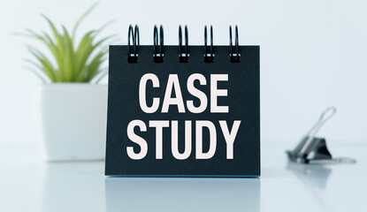 A black case study is on a white table