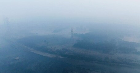 Aerial view of serene Yamuna Ghat with fog, India. - Powered by Adobe