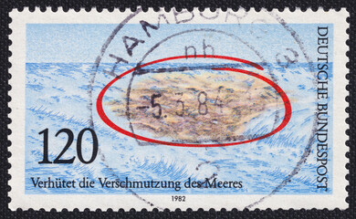 Large garbage patch at sea on a 1982 Germany postage stamp. Prevent the Pollution of the Sea, Nature and Environmental Protection.