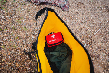 Inside a bright yellow bag, youll find a red first aid kit that is crucial for handling unexpected...