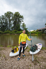 An Outdoor Adventurer is gearing up for an exciting kayaking experience on a beautiful river,...