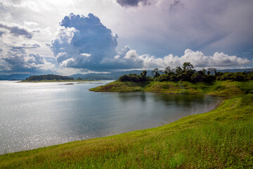 Fototapeta premium Panoramic view of Arenal Volcano National Park in Costa Rica, with Arenal Lagoon in the foreground