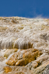 Scenic landscape view of steam rising from the Travertine Terraces at Mammoth Hot Springs in Yellowstone National Park