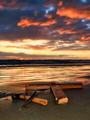 Cross Laid Down On Beach Sunset.