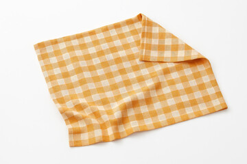 A checkered orange and white napkin isolated on white background