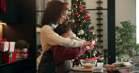 Christmas, baking and mom with child in kitchen with bowl for cookies, dessert and cake recipe. Family, home and mother with girl with ingredients for teaching, baker skills and holiday tradition - Powered by Adobe