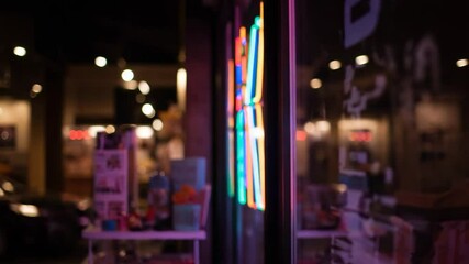 Neon lights reflecting in shop window at night with blurred background - Powered by Adobe